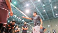 Qatar coach Camilo Soto supervises team's training session. 