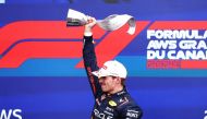 Race winner Max Verstappen of the Netherlands and Oracle Red Bull Racing celebrates with his trophy on the podium after the F1 Grand Prix of Canada at Circuit Gilles Villeneuve on June 09, 2024 in Montreal, Quebec. (Photo by Mark Thompson/Getty Images via AFP)