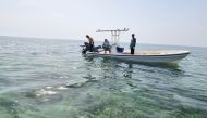 MECC officials seizing the fishing net.