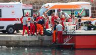 Italian firefighters and health workers carry a body bag with a victim after a sailboat sank off the coast of Porticello, nosthwestern of Sicily Island, on August 19, 2024. Photo by Igor Petyx / ANSA / AFP.