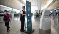 A Cathay Pacific employee moves a sign board at the international airport in Hong Kong on September 4, 2024. Photo by Peter PARKS / AFP