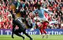 Nottingham Forest's Swedish midfielder #21 Anthony Elanga (front R) jumps for the ball during the English Premier League football match between Liverpool and Nottingham Forest at Anfield in Liverpool, north west England on September 14, 2024. (Photo by Ian Hodgson / AFP) 