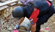 A handout photo distributed on September 22, 2024 by the Ministry of the Interior of Serbia, shows a special police unit officer near an unexploded 300-kilo WWI artillery round at a construction site near the Serbian Parliament in Belgrade. Photo by HANDOUT / Ministry of the Interior of Serbia / AFP