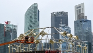 File photo of workers assembling a structure near the financial business district in Singapore.