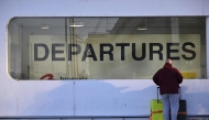 A passenger stands at the departures terminal during a strike at the Brussels Airport, in Zaventem on January 13, 2025. (Photo by Eric Lalmand / Belga / AFP) 
