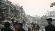 Rescuers search for survivors amid the rubble of the collapsed Sky Villa Condominium building in Mandalay on March 29, 2025. (Photo by Sai Aung MAIN / AFP)