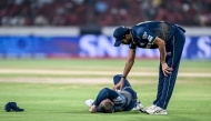 Gujarat Titans' Washington Sundar (R) checks on his teammate Glenn Phillips during the Indian Premier League (IPL) Twenty20 cricket match in Hyderabad on April 6, 2025. (Photo by Noah Seelam / AFP) 