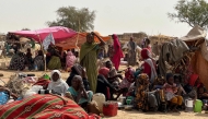 People who fled the Zamzam camp for the internally displaced after it fell under RSF control, rest in a makeshift encampment in an open field near the town of Tawila in war-torn Sudan's western Darfur region on April 13, 2025. (Photo by AFP)
