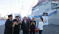 This picture taken on April 25, 2025 and released from North Korea's official Korean Central News Agency (KCNA) on April 26, 2025 shows North Korean leader Kim Jong Un (C) and his daughter Ju Ae (R) attending the launch ceremony of a newly-built destroyer at the Nampo port in Nampo. (Photo by KCNA VIA KNS / AFP)