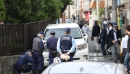 Police officers investigate the scene in Osaka's Nishinari district on May 1, 2025, after a man was arrested after allegedly ploughing his car into schoolchildren. (Photo by JIJI PRESS / AFP)