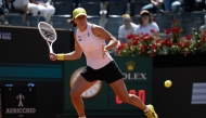 Poland's Iga Swiatek returns the ball to Italy's Elisabetta Cocciaretto during their match of the WTA Rome Open tennis tournament at the Foro Italico in Rome, on May 8, 2025. (Photo by Marco Bertorello / AFP)