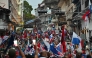 Workers carrying national flags take part in a protest against the government of President Jose Raul Mulino amid an indefinite strike in Panama City on May 23, 2025. (Photo by Martin Bernetti / AFP)