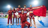 The members of the Qatar 4x400m relay team and 3000m steeplechase bronze medallist Zakaria Elahlaami (foreground) pose for a photo.