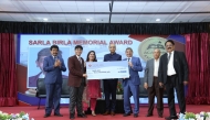 Officials and guests with a winner at awards ceremony.