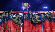 Royal Challengers Bengaluru's Virat Kohli, along with his teammates, celebrates with the trophy after winning the Indian Premier League (IPL) Twenty20 final cricket match against Punjab Kings at the Narendra Modi Stadium in Ahmedabad on June 4, 2025. (Photo by Arun Sankar / AFP)