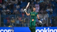 South Africa's Aiden Markram celebrates after scoring a century (100 runs) during the 2023 ICC Men's Cricket World Cup one-day international (ODI) match between South Africa and Sri Lanka on October 7, 2023. (Photo by Sajjad Hussain / AFP)