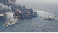 This handout photograph taken and released on June 10, 2025 by the Indian Coast Guard (ICG) shows smoke billowing from Singapore-flagged container ship MV Wan Hai 503 that caught fire 78 nautical miles off Beypore port in India's Kerala state. (Photo by Indian Coast Guard (ICG) 