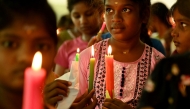 Children hold candles as they pray for the deceased killed in the June 12 Air India flight 171 crash in Ahmedabad, at an orphanage in Chennai on June 14, 2025. Photo by R.Satish BABU / AFP.
