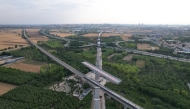 A swivel bridge along Xiong'an-Baoding section of Xiong'an-Xinzhou high-speed railway before rotating to its desired position over Beijing-Guangzhou high-speed railway in Baoding, north China's Hebei Province, on June 17, 2025. (Xinhua/Xing Guangli)