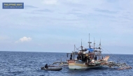This handout photo taken on June 20, 2025 and received from the Philippine Navy shows navy and law enforcement personnel searching a fishing boat after it was intercepted carrying 1.5 tonnes of illegal drugs off the coast of the main island Luzon. Photo by Handout / Philippine Navy / AFP