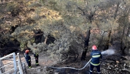 Croatian firefighters operate water hoses and other equipment during a wildfire near the coastal town of Omis on June 21, 2025. (Photo by ELVIS BARUKCIC / AFP)
