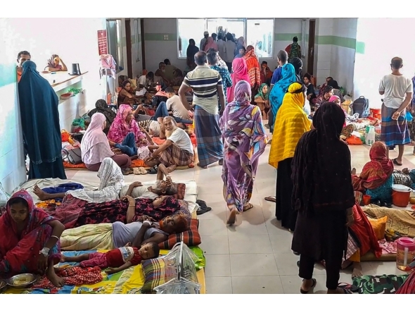 File photo. Dengue patients along with their family members are pictured at a hospital in Barguna in southern Bangladesh on June 22, 2025. (Photo by Arifir Rahman / AFP)