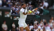 Serbia’s Novak Djokovic plays a forehand return to Britain’s Daniel Evans.