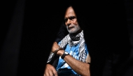 A Protester is pictured in handcuffs through a police officers legs before being carried away after being arrested as people gather in support of the pro-palestinian group