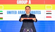 An official picks Qatar during the official draw ceremony.