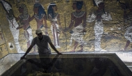 Representational file photo showing an Egyptian archaeologist looks at the sarcophagus of King Tutankhamun in his burial chamber in the Valley of the Kings, close to Luxor.
