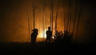 Firefighters work on a wildfire in Arouca, northern Portugal on July 30, 2025. (Photo by CARLOS COSTA / AFP)