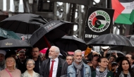 Demonstrators including WikiLeaks founder Julian Assange (3rd L, wearing red tie) cross the Sydney Harbour Bridge during a pro-Palestinian rally against Israel's actions and the ongoing food shortages in the Gaza Strip, in Sydney on August 3, 2025. (Photo by DAVID GRAY / AFP)