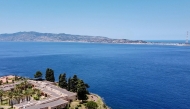 A general aerial view shows the Sicilian coast towards Cape Torre Faro, over the Strait of Messina, taken from the outskirts of the town of Scilla, in Calabria region in southern Italy, on July 7, 2020. Photo by Andreas SOLARO / AFP