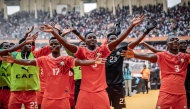 Kenya players celebrate their team victory after the African Nations Championship (CHAN) group stage football match between Kenya and Morocco at Kasarani Stadium in Nairobi, on August 10, 2025. (Photo by Luis TATO / AFP)