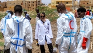 Members of the Sudanese Red Crescent and forensic experts exhume the remains of people from makeshift graves for reburial in the local cemetery in Khartoum's southern suburb of al-Azhari on August 2, 2025 after the dead were buried in a rush when the area was under control of the Rapid Support Forces (RSF) paramilitaries. (Photo by Ebrahim Hamid / AFP)

