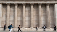 Pedestrians walk past the Bank of England, in the City of London, on August 7, 2025. Photo by Niklas HALLE'N / AFP