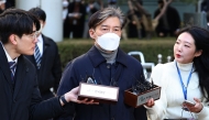 Cho Kuk (C), a former aide to South Korea's former president Moon Jae-in, leaves after his trial at the Seoul Central District Court in Seoul on February 3, 2023. Photo by YONHAP / AFP


