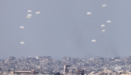Aid packages are airdropped over the Gaza Strip, as seen from southern Israeli border with Gaza, on August 9, 2025. (Photo by Jamal Awad/Xinhua)