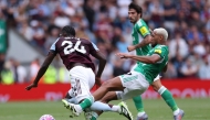 Newcastle United's Brazilian midfielder #07 Joelinton (R) fouls Aston Villa's Belgian defender #24 Amadou Onana (L) during the English Premier League football match between Aston Villa and Newcastle United at Villa Park in Birmingham, central England on August 16, 2025. (Photo by Adrian Dennis / AFP) 