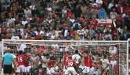 Manchester United's Turkish goalkeeper #01 Altay Bayindir is unable to reach the ball from an Arsenal corner as Arsenal's Italian defender #33 Riccardo Calafiori (R) prepares to head in the opening goal during the English Premier League football match between Manchester United and Arsenal at Old Trafford in Manchester, north west England, on August 17, 2025. (Photo by Paul ELLIS / AFP) 