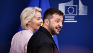Ukraine's President Volodymyr Zelensky and European Commission President Ursula Von der Leyen leave at the end of a joint press conference in Brussels, on August 17, 2025. (Photo by Simon Wohlfahrt / AFP)
