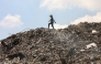A Palestinian girl searches for things to rescue at a garbage waste dump in Gaza City on August 18, 2025. (Photo by Omar Al-Qattaa / AFP)