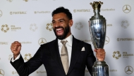 Liverpool's Egyptian striker Mohamed Salah poses with the Men's PFA Players' Player of the Year award backstage during the 2024-2025 Professional Footballers' Association (PFA) awards, at the Opera House in Manchester, northern England, on August 19, 2025. (Photo by Darren Staples / AFP)
