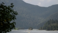 Tourists ride rental boats on the Eibsee lake, near Grainau, Garmisch-Partenkirchen, southern Germany on August 22, 2025. (Photo by Philipp Guelland / AFP)