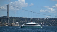 A new fast ferry sails on Bosphorus in Istanbul, on August 26, 2025, next to the 15 July Martyrs Bridge, known as Bosphorus bridge. (Photo by Ozan Kose / AFP)