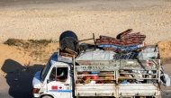 Displaced Palestinians fleeing in a truck with belongings along the coastal road through the Nuseirat camp in the central Gaza Strip on August 30, 2025. (Photo by Eyad Baba / AFP)