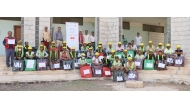 A group of the project's beneficiaries with carpentry toolkits.