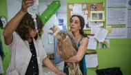Members of the Greek wildlife protection group Anima treat an injured vulture at an Athens animal clinic on August 26, 2025. (Photo by Aris Messinis / AFP)