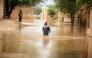 A woman wades through flood waters at a flood-hit area on the outskirts of Multan, Pakistan on Sept. 2, 2025. (Str/Xinhua)
