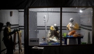 (FILES) Health workers treat an unconfirmed Ebola patient, inside a MSF (Doctors Without Borders) supported Ebola Treatment Centre (ETC) on November 3, 2018 in Butembo, Democratic Republic of the Congo. (Photo by John WESSELS / AFP)
